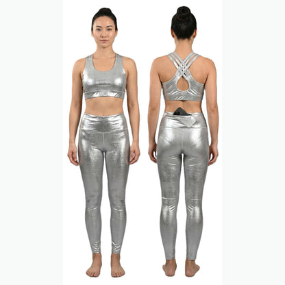 A woman modeling a shiny metallic silver two-piece activewear set, shown from both the front and back views against a plain white background.