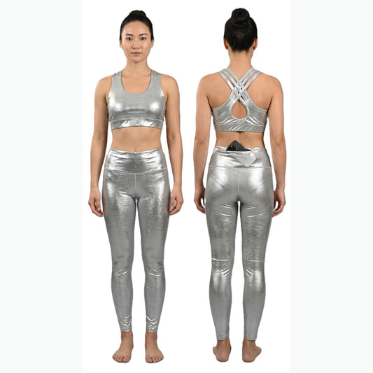 A woman modeling a shiny metallic silver two-piece activewear set, shown from both the front and back views against a plain white background.